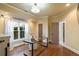 Home office with a glass desk, hardwood floors, multiple windows for natural light and two doors at 1207 Thornwell Ne Dr, Brookhaven, GA 30319