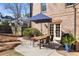 Outdoor patio with a dark metal table, chairs, and a blue umbrella, perfect for relaxing at 1207 Thornwell Ne Dr, Brookhaven, GA 30319