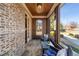 Comfortable sunroom with brick and shingle walls, featuring cozy seating and serene outdoor views at 1207 Thornwell Ne Dr, Brookhaven, GA 30319
