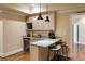 Basement wet bar with marble counters, seating, wine storage, and stylish pendant lighting at 1207 Thornwell Ne Dr, Brookhaven, GA 30319