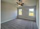 A spacious bedroom, with a ceiling fan, and windows with outdoor views at 219 Willow St, Canton, GA 30114