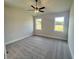 A spacious bedroom, with a ceiling fan, and windows with outdoor views at 219 Willow St, Canton, GA 30114