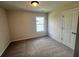 A carpeted bedroom, featuring a large window offering views of the outdoors at 219 Willow St, Canton, GA 30114