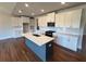 Bright, open kitchen with quartz countertops, white cabinets, and a navy-blue kitchen island at 219 Willow St, Canton, GA 30114