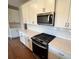Modern kitchen with white cabinets, stainless steel appliances, and quartz countertops at 219 Willow St, Canton, GA 30114