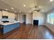 Open-concept living room and kitchen featuring hardwood floors, a fireplace, and ample natural light at 219 Willow St, Canton, GA 30114
