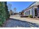 Large backyard with a patio area featuring a fire pit, screened-in porch, and mature trees at 3905 Alister Park Dr, Cumming, GA 30040