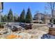 Outdoor patio featuring stone flooring, built-in brick fire pit, and cozy seating area at 3905 Alister Park Dr, Cumming, GA 30040