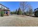 Spacious backyard with a patio area featuring a fire pit, enclosed sunroom and mature trees at 3905 Alister Park Dr, Cumming, GA 30040