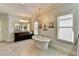 Bright bathroom features soaking tub, large vanity and decorative light fixture at 3905 Alister Park Dr, Cumming, GA 30040