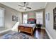 Comfortable bedroom with neutral walls, wood furniture, ceiling fan, and stylish decor at 3905 Alister Park Dr, Cumming, GA 30040