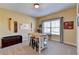 Bonus room with vaulted ceiling features craft table, art, and neutral color palette at 3905 Alister Park Dr, Cumming, GA 30040