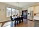 Bright dining area with a large window, modern lighting, and stainless steel appliances creates an inviting atmosphere at 3905 Alister Park Dr, Cumming, GA 30040