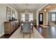 Hardwood floors, chandelier, built in shelving, and large sideboard highlight this dining area at 3905 Alister Park Dr, Cumming, GA 30040