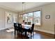 Bright dining room features hardwood floors, large window, and elegant pendant lighting at 3905 Alister Park Dr, Cumming, GA 30040