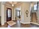 Entryway with dark hardwood floors, staircase with carpet runner, and an ornate decorative clock at 3905 Alister Park Dr, Cumming, GA 30040