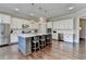 Modern kitchen with white cabinetry, a spacious island with seating, and hardwood floors for a sophisticated look at 3905 Alister Park Dr, Cumming, GA 30040