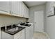 Laundry room features washer, dryer, utility sink and extra storage at 3905 Alister Park Dr, Cumming, GA 30040
