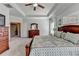 Bright main bedroom with tray ceiling, large bed, dresser, and windows at 3905 Alister Park Dr, Cumming, GA 30040