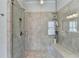 Walk-in shower features neutral tile, built-in bench and recessed shelf at 3905 Alister Park Dr, Cumming, GA 30040