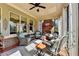 Charming sunroom with comfortable seating, brick accent wall, and lots of natural light at 3905 Alister Park Dr, Cumming, GA 30040
