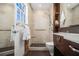 Updated bathroom featuring a walk-in shower with a shower seat, along with custom cabinets and shelves at 436 Avery St, Decatur, GA 30030