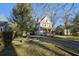 Exterior shot of a well-maintained home with a long driveway and mature trees on a sunny day at 436 Avery St, Decatur, GA 30030