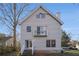Rear exterior of the home featuring a small upper level deck, access to the backyard, and ample parking at 436 Avery St, Decatur, GA 30030