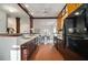 A bright eat-in kitchen features brick floors and stainless-steel appliances; adjacent to the dining area at 436 Avery St, Decatur, GA 30030