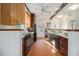 A bright eat-in kitchen features brick floors, two-tone cabinets and stainless-steel appliances at 436 Avery St, Decatur, GA 30030
