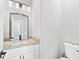 Modern bathroom featuring granite countertops, a framed mirror, and a sink at 2021 Pinnacle Pointe Dr, Norcross, GA 30071