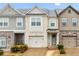 Charming townhomes featuring garages and diverse exteriors with stylish stonework and neutral color palettes at 2271 Rolling Trl, Lithonia, GA 30058