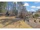 A view of the backyard with an outdoor fireplace, pergola, and partially visible gazebo at 3290 Spain Rd, Snellville, GA 30039
