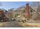 Backyard with a brick chimney, pergola, and covered patio, perfect for outdoor relaxation at 3290 Spain Rd, Snellville, GA 30039