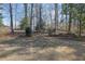 Expansive backyard with mature trees, and landscaping offering a private, serene setting at 3290 Spain Rd, Snellville, GA 30039