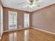 Bedroom with hardwood floors, fan, and shuttered windows at 3290 Spain Rd, Snellville, GA 30039