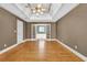Bedroom with hardwood floors, tray ceiling, and doorway to bathroom at 3290 Spain Rd, Snellville, GA 30039