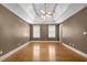 Bedroom with hardwood floors, tray ceiling, and a ceiling fan at 3290 Spain Rd, Snellville, GA 30039