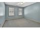 This bedroom features a neutral palette, two windows, and a ceiling fan at 3290 Spain Rd, Snellville, GA 30039