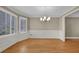 Light-filled dining room showcasing hardwood floors, modern lighting, and decorative wainscoting at 3290 Spain Rd, Snellville, GA 30039