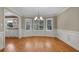 Bright dining room with bay window, hardwood floors, modern lighting, and classic wall trim at 3290 Spain Rd, Snellville, GA 30039