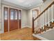 Inviting entryway features hardwood floors, wooden front door, and staircase with white spindles at 3290 Spain Rd, Snellville, GA 30039