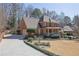 Beautiful brick home with a long driveway, front porch, and meticulously maintained landscaping at 3290 Spain Rd, Snellville, GA 30039
