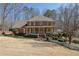Charming brick home featuring a welcoming front porch, manicured lawn and mature landscaping at 3290 Spain Rd, Snellville, GA 30039
