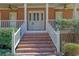 Inviting front porch featuring brick stairs, classic columns, and a stylish front door at 3290 Spain Rd, Snellville, GA 30039