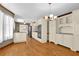 Spacious kitchen featuring hardwood floors, stainless appliances, granite countertops, and white cabinetry at 3290 Spain Rd, Snellville, GA 30039