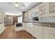 Bright kitchen with granite countertops, stainless steel appliances, and farm sink under a window at 3290 Spain Rd, Snellville, GA 30039