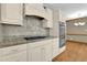 Modern kitchen with granite countertops, gas cooktop, stainless appliances, and shaker-style cabinets at 3290 Spain Rd, Snellville, GA 30039