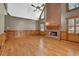 Spacious living room featuring a brick fireplace, hardwood floors, and ample natural light at 3290 Spain Rd, Snellville, GA 30039