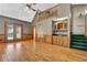 Living room featuring hardwood floors, wet bar, and access to stairs leading to a second floor space at 3290 Spain Rd, Snellville, GA 30039